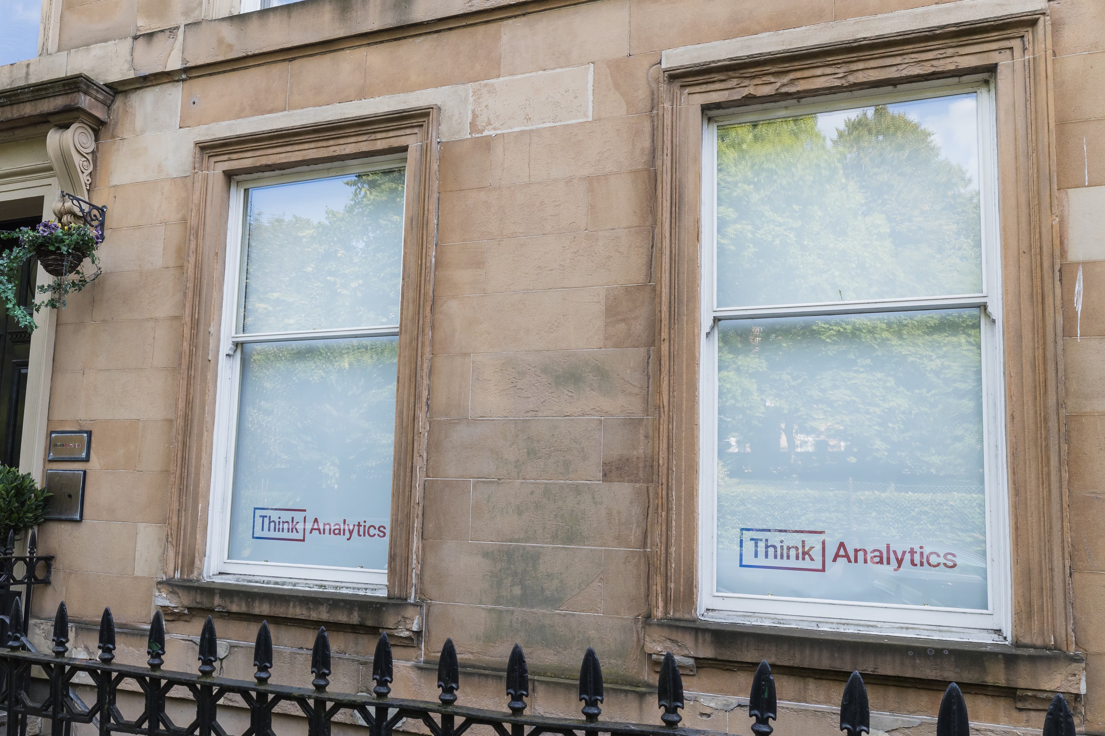 Think Analytics custom logo printed roller blinds on townhouse office windows