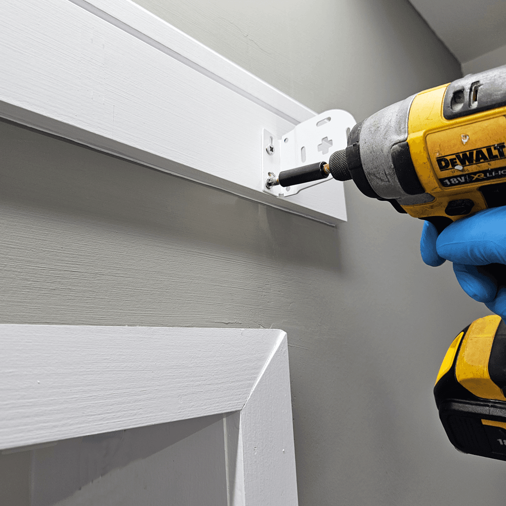 Drill marked fixing holes and securely fix both brackets