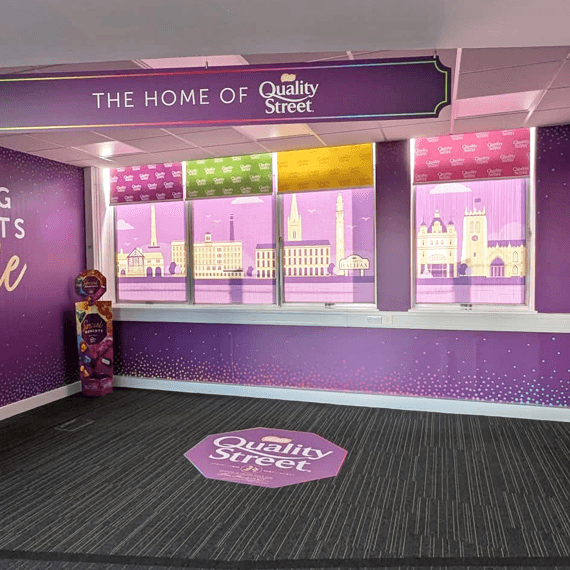 Full room panoramic view of the Quality Street branded installation with multiple printed blinds
